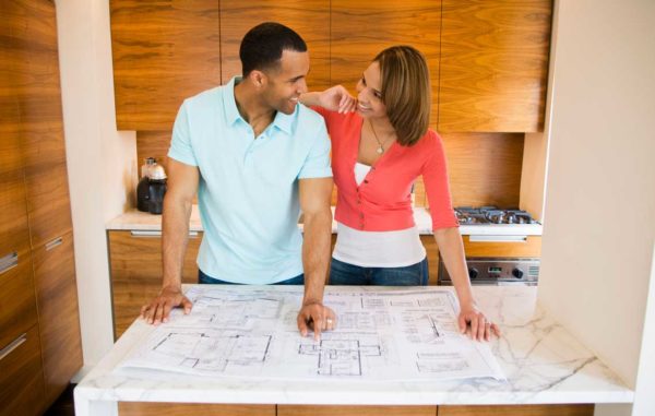 Husband and wife looking at architectural plans for their home