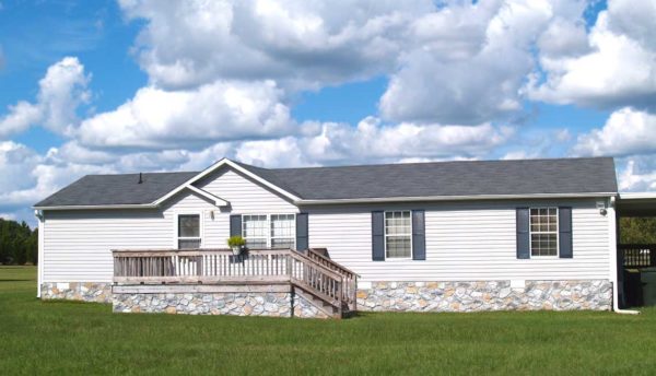 Facade of a house in a grassy plain